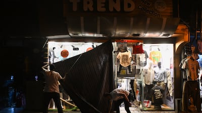 A man closes his shop amid a heatwave in Cairo, after the government had ⁣ordered early closure of businesses to​ save ​energy. EPA