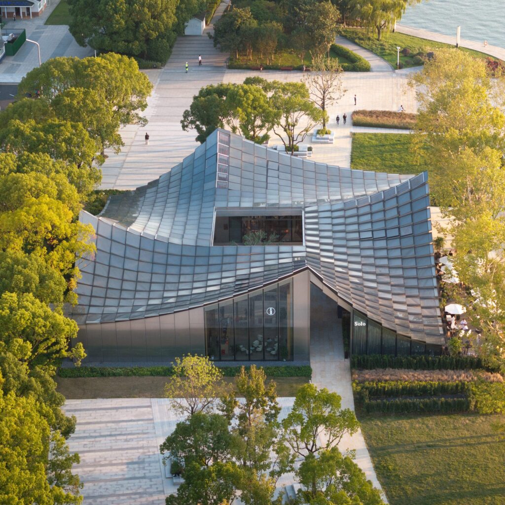 BIG unveils jinji lake pavilion with pixelated glass roof on suzhou’s waterfront – Designboom