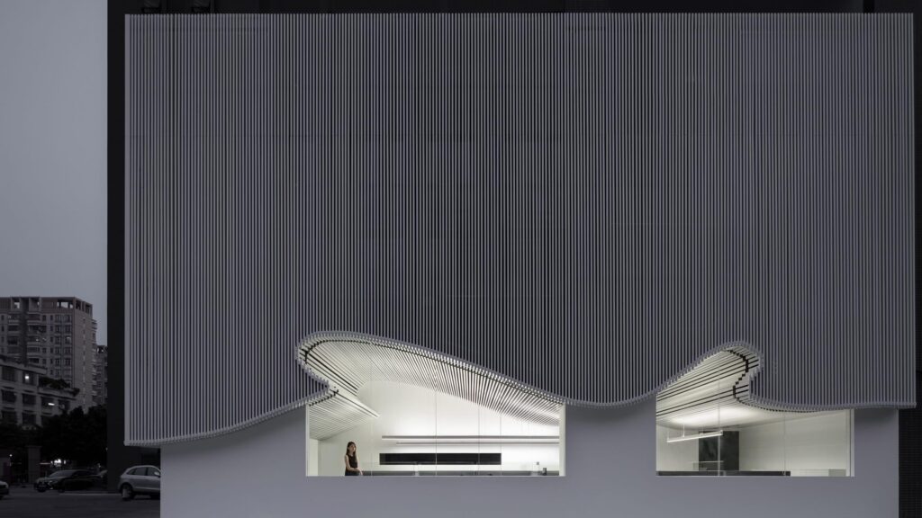 curved textile facades wrap reborn house in bangkok village emitting soft glow – Designboom